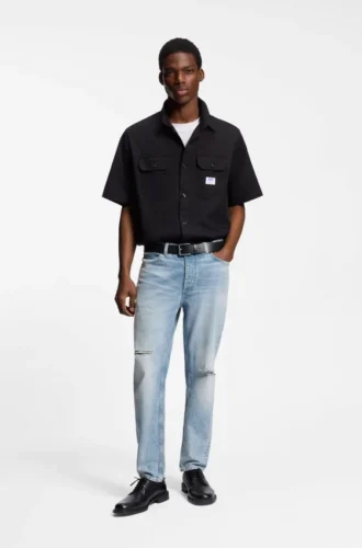 Blaue, konisch geschnittene Jeans aus Distressed-Denim