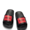 Kinderschlipper mit Logo-Riemen aus PVC Kinderschlipper mit Logo-Riemen aus PVC