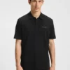 Polohemd mit Logo-Applikation aus Baumwollpiqué