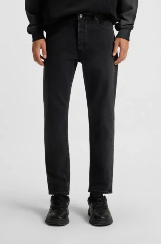 Schwarze Jeans mit schmal zulaufender Passform aus Denim mit Narbeneffekt