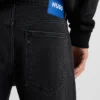 Schwarze Jeans mit schmal zulaufender Passform aus Denim mit Narbeneffekt