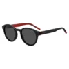 Schwarze Sonnenbrille mit rundem Rahmen und gemusterten Bügeln