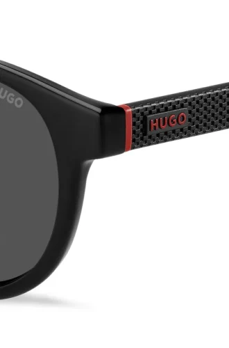 Schwarze Sonnenbrille mit rundem Rahmen und gemusterten Bügeln